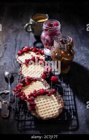 Wafers with chocolate and raspberries.Aromatic coffee.Sweet dessert.Healthy food and sweets. Stock Photo