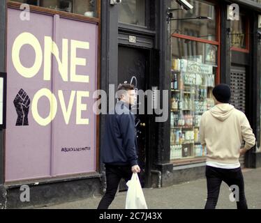 Glasgow, Scotland, UK 17th July, 2020: The city centre has changed to a wasteland of empty boarded up shops with protest murals ans sparse pedestrians the new Friday night out in the city centre..Mitakon art lens 0.95 mark iii canon R camera.  Credit: Gerard Ferry/Alamy Live News Stock Photo