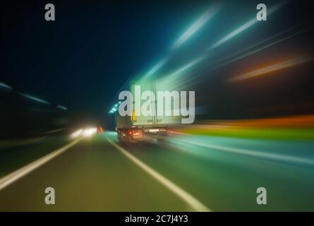 truck moves on country highway at night Stock Photo