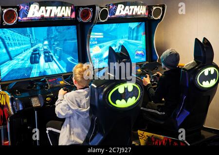 boys playing an arcade game on a ferry, Denmark Stock Photo