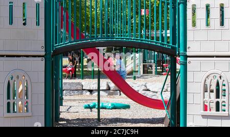 Barrie, Canada. 17th July, 2020. A boy plays at a reopened playground in Barrie, Ontario, Canada, on July 17, 2020. The majority of Ontario moved into Stage 3 of the provincial government's COVID-19 recovery plan on Friday, with fitness centers, movie theaters, playgrounds and restaurants' indoor service allowed to reopen. The Greater Toronto Area will remain in Stage 2. Credit: Zou Zheng/Xinhua/Alamy Live News Stock Photo