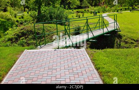 Pavement and Footbridge in the Green Park . No People in the City Park Stock Photo