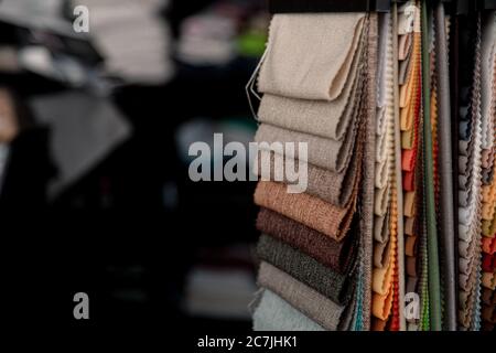 Lot of colorful folded textiles in a tailors studio Stock Photo