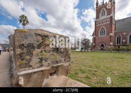 More likely a stone cutter's mark than that of a love lost soul, this upside down heart is beautifully marked in the fence at St Johns in Mudgee Aust. Stock Photo