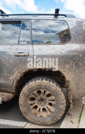 A mud covered and splattered four wheel drive (4WD) Toyota parked in the regional town of Mudgee, New South Wales, Australia Stock Photo