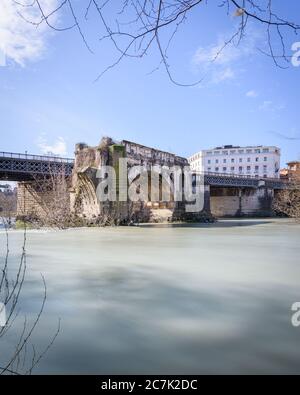 Emilio bridge or Ponte Rotto, ancient Roman bridge over the Tiber river, near the Isola Tiberina island in Rome, Italy Stock Photo