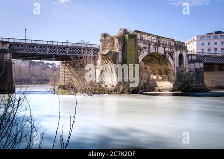 Emilio bridge or Ponte Rotto, ancient Roman bridge over the Tiber river, near the Isola Tiberina island in Rome, Italy Stock Photo