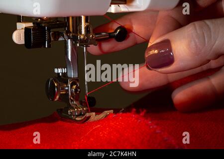 Sewing on sewing machine with beautiful female hands Stock Photo