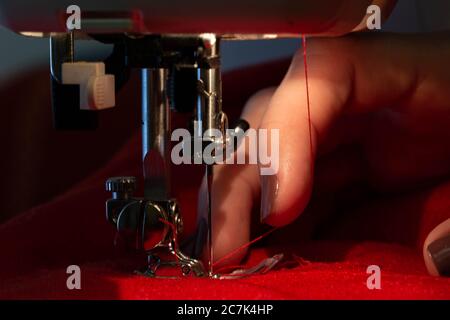 Sewing on sewing machine with beautiful female hands Stock Photo