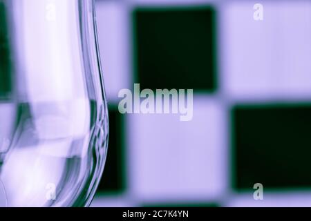 Part of glass amid black and white squares Stock Photo