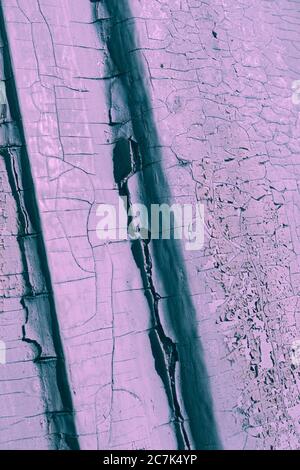 Photo in grey-pink tones of old cracked paint on wooden surface Stock Photo