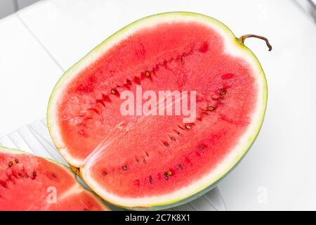 ripe red watermelon cut in half. bright red watermelon pulp Stock Photo