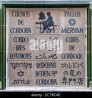 A traditional azulejos sign for a leather craftsman in a narrow street in Córdoba Stock Photo