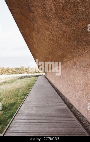 Closeup shot of a roof made of concrete having a wooden walkaway underneath Stock Photo