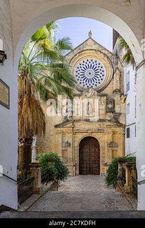 The Mannerist styled 16th century façade of the Real Iglesia de San Pablo framed by an archway on Calle Capitulares Stock Photo