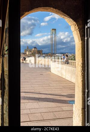 Cordoba's Mosque-Cathedral and Puente Romano through the arched doorway of the Torre de la Calahorra Stock Photo