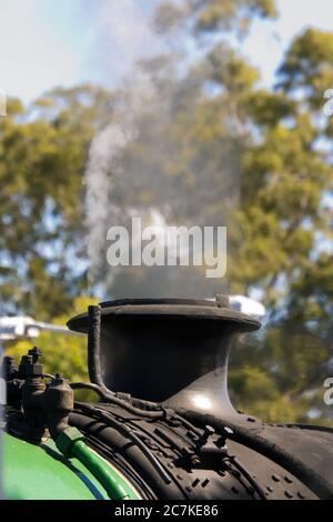 Vertical closeup shot of the steam getting out of a tube on a wagon Stock Photo