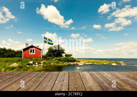 Red swedish ahus with wooden terrace Stock Photo
