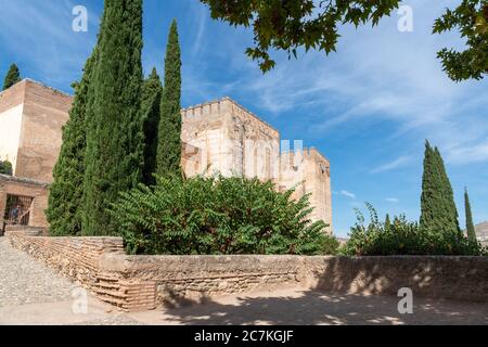 The Torre Quebrada (Cracked Tower), Torre del Homenaje (Keep) and impressive walls of the Alcazaba (Old Citadel) from Plaza de los Aljibes Stock Photo