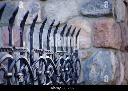 Closeup shot of the beautiful patterned details of an iron fence Stock Photo