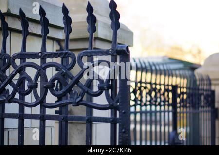Closeup shot of the beautiful patterned details of an iron fence Stock Photo