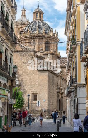 The dome and tower of the Jesuit Iglesia de San Justo y San Pastor rise over Calle de San Jeronimo and University Square in Granada. Stock Photo