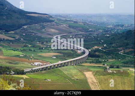 View of a high road through the beautiful landscape near the temple of Segesta in Sicily Stock Photo