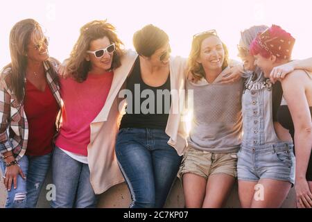 Group of adult and young caucasian friends enjoy together in friendship without social distance in freedom - beautiful mixed generations women have fun together outdoor Stock Photo