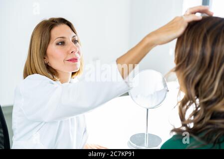 Consultation in cosmetology clinic. Female doctor talking with patient