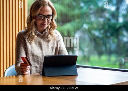 Woman shopping using tablet pc and credit card Stock Photo