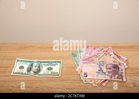 100 Dollar and Turkish Money on wooden table Stock Photo