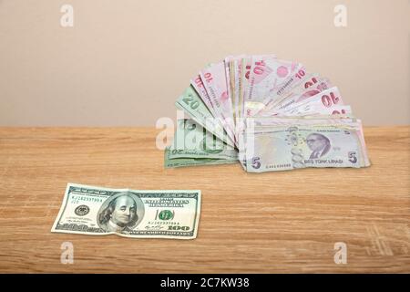 100 Dollar and Turkish Money on wooden table Stock Photo