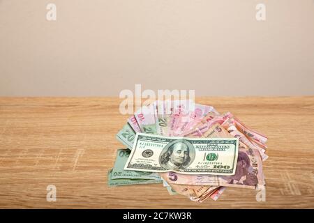 100 Dollar and Turkish Money on wooden table Stock Photo