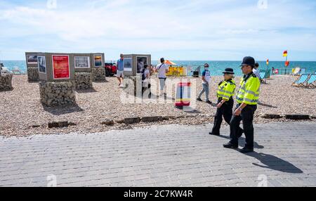 Brighton UK 18th July 2020 - Police officers on patrol along Brighton beach on a beautiful sunny day on the South Coast with temperatures expected to reach the high 20s in some parts of Britain : Credit Simon Dack / Alamy Live News Stock Photo