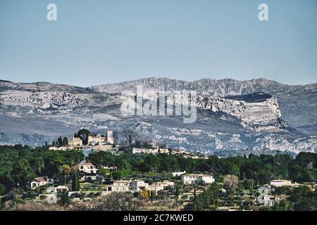 Beautiful shot of buildings with mountains in the distance under a blue sky in Mougins, France Stock Photo
