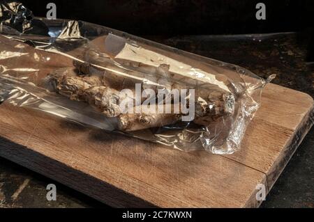 cut ginger on a dark background Stock Photo