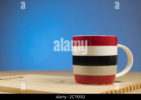 Red-white-blue mug on a blue background. The concept of a friendly company, a big family, meeting friends for a cup of tea or coffee Stock Photo