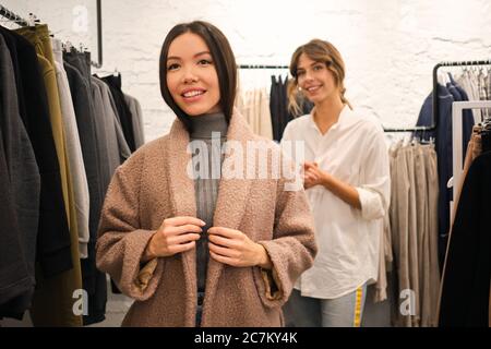 Stylish beautiful girl in designer clothes. She wore a tunic, blue lace. It  is made in the technology of nunovolok on white rarefied silk of merino wo  Stock Photo - Alamy