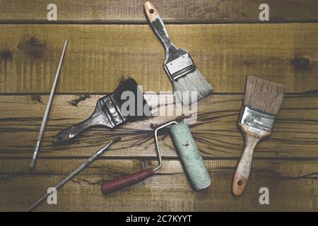Top view shot of different painting materials on a wooden workbench Stock Photo