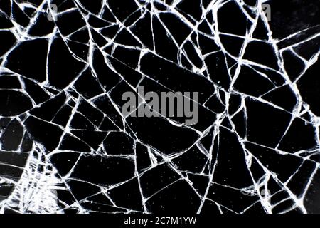Broken glass tablet computer. Cracked screen. Cracks in the glass on black background. Stock Photo