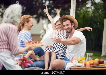 Happy family have fun, laughing.Young  family enjoying summer together at backyard. Stock Photo