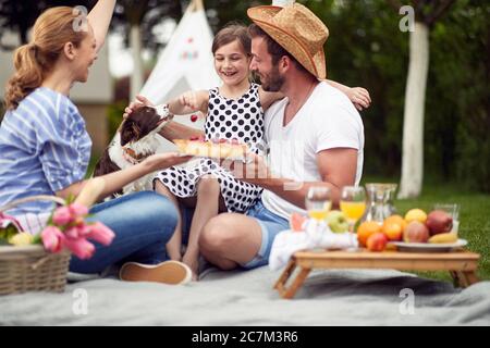 Happy family enjoying summer together at backyard. Stock Photo