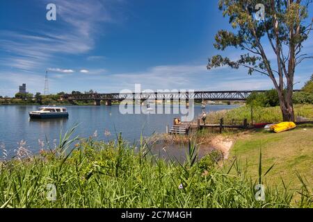 A peaceful scene on the River Clarence at Grafton with jetty and boat, on the mid east coast of New South Wales, Australia. Stock Photo