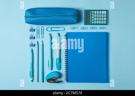 Flat lay with different school supplies on blue background Stock Photo