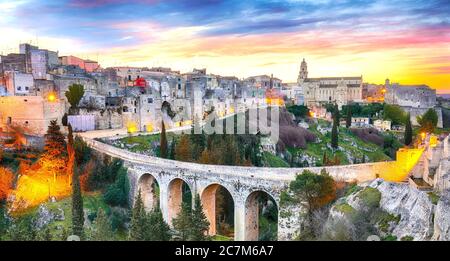 Gravina in Puglia ancient town, bridge and canyon at sunrise. Panoramic view of old city Gravina in Puglia, Apulia, Italy. Europe Stock Photo