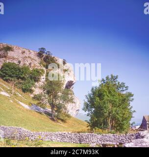 This is geological-geographical overhanging limestone wonder of Kilnsey Crag near the Yorkshire Dales village of Kettlewell in the spring of 1980 Stock Photo