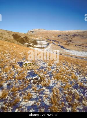 This is Ingleborough mountain in winter  viewed from Crina Bottom hill farm one of the famous Yorkshire Dales Three Peaks of Ingleborough, Whernside and Penyghent around 1980 Stock Photo