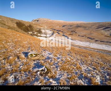 This is Ingleborough mountain in winter  viewed from Crina Bottom hill farm one of the famous Yorkshire Dales Three Peaks of Ingleborough, Whernside and Penyghent around 1980 Stock Photo