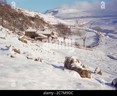 This is Ingleborough mountain in winter  viewed from Crina Bottom hill farm one of the famous Yorkshire Dales Three Peaks of Ingleborough, Whernside and Penyghent around 1980 Stock Photo