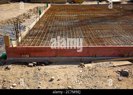 Rusty reinforcement steel mesh mats prepared for a base plate on a construction site Stock Photo